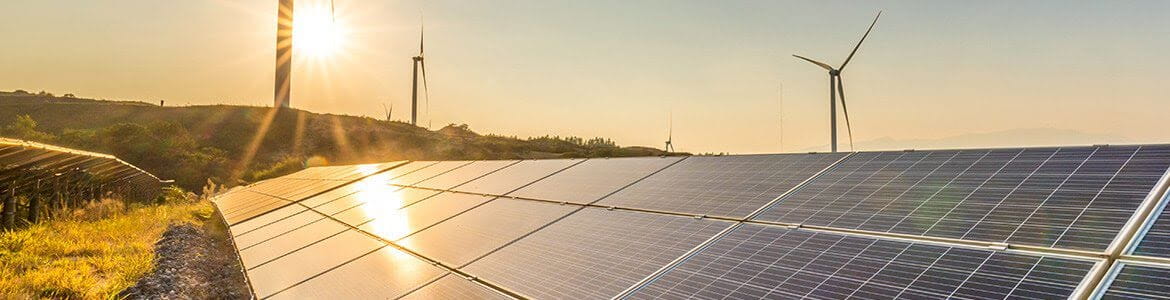 Renewable energy farm showing solar panels and wind turbines