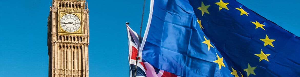 UK Union Jack Flag alongside some European Union flags and Big Ben in background